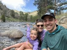 Emma, Josh, and Nora posing in the Poudre river 